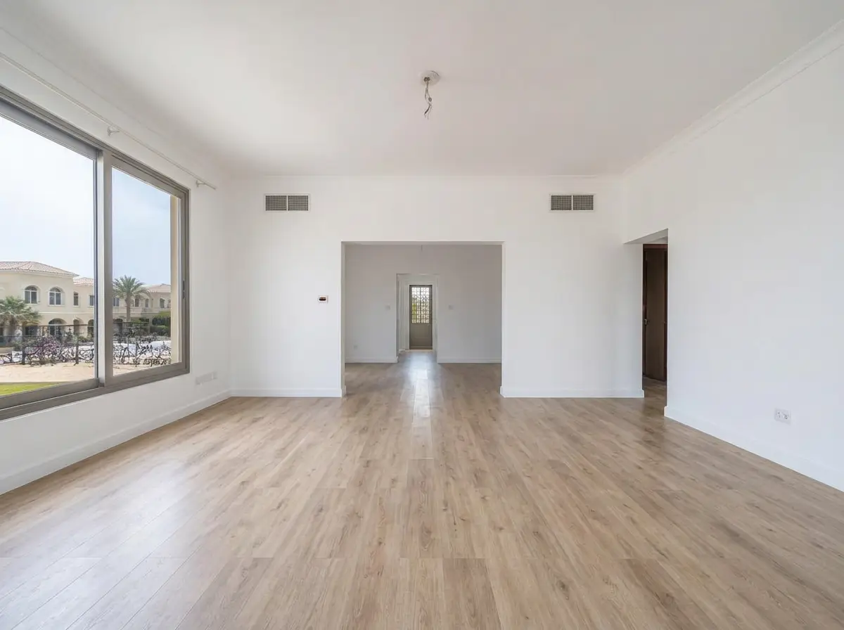 Villa living room with light oak vinyl flooring and white walls after renovation in Arabian Ranches